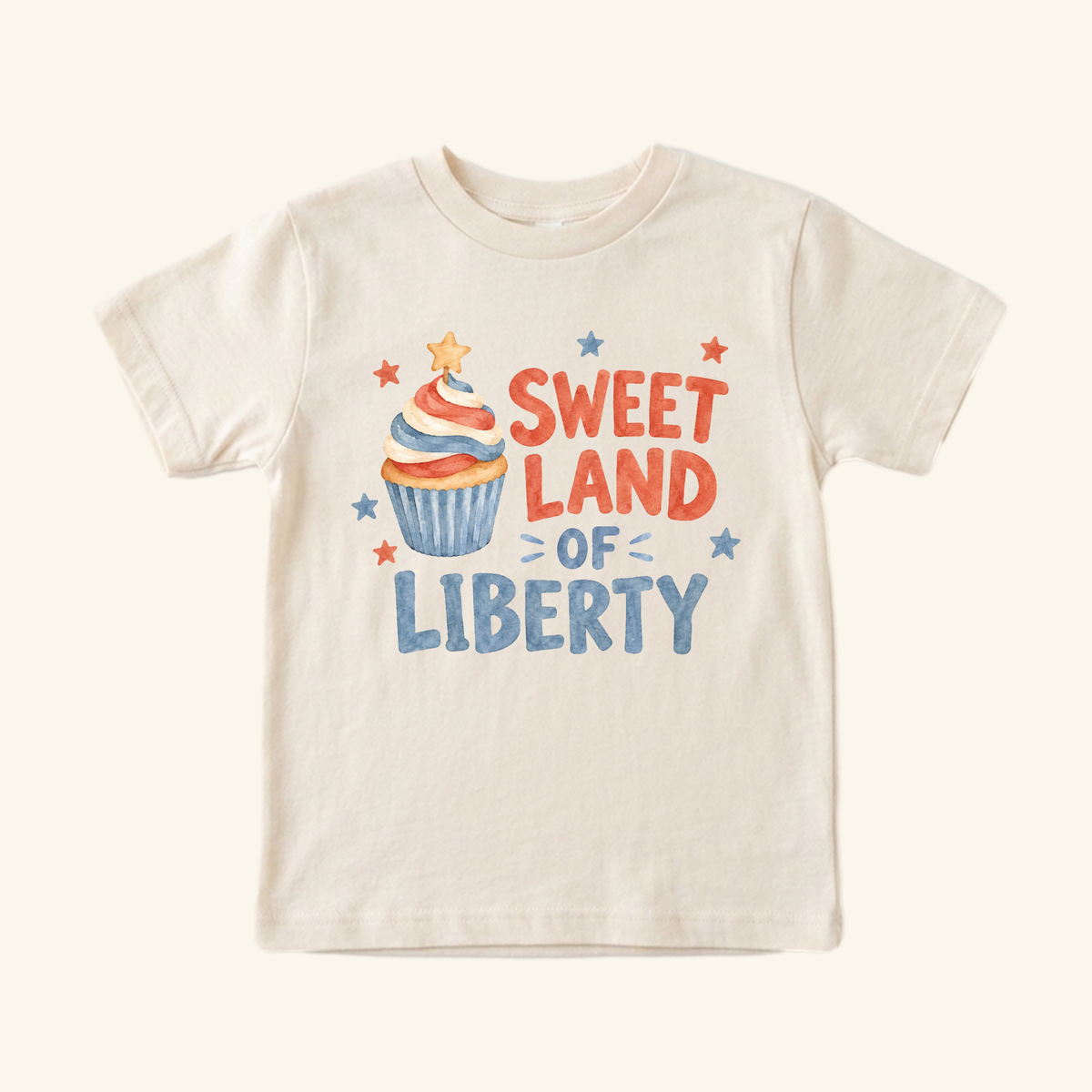 Cream-colored Sweet Land of Liberty Toddler Shirt – Patriotic Cupcake Tee featuring a cupcake illustration and the text Sweet Land of Liberty surrounded by small stars.
