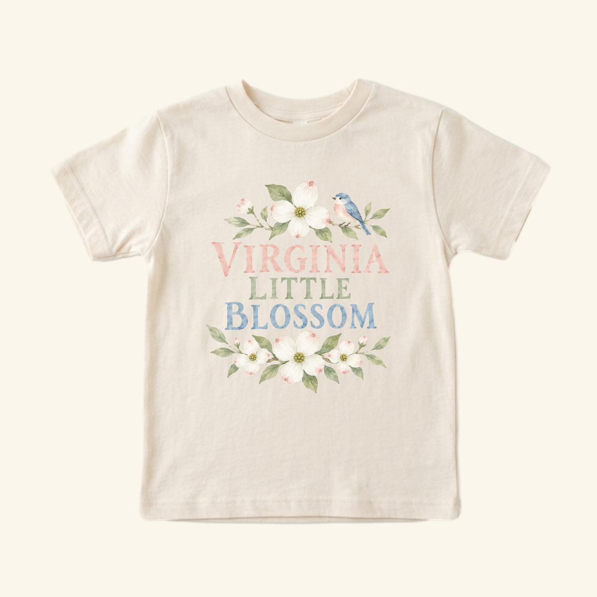 Virginia Toddler Shirt – Little Blossom Dogwood Floral Tee: a short-sleeved cream toddler tee featuring a watercolor illustration of dogwood flowers, a small blue bird, and the text VIRGINIA LITTLE BLOSSOM.