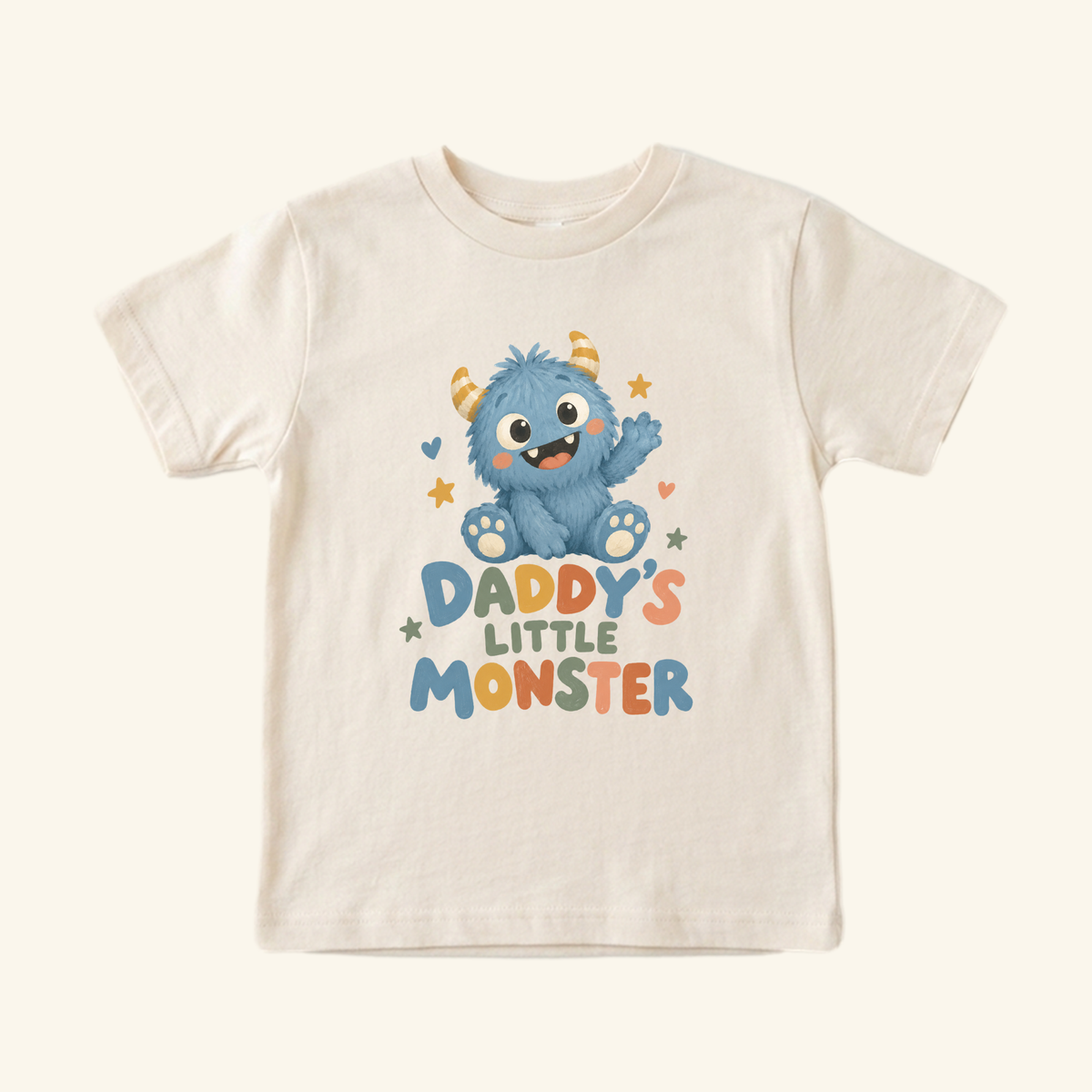 Cream Toodleroos Daddy’s Little Monster Toddler Shirt featuring a blue cartoon monster waving and the text Daddy’s Little Monster in colorful, playful lettering.