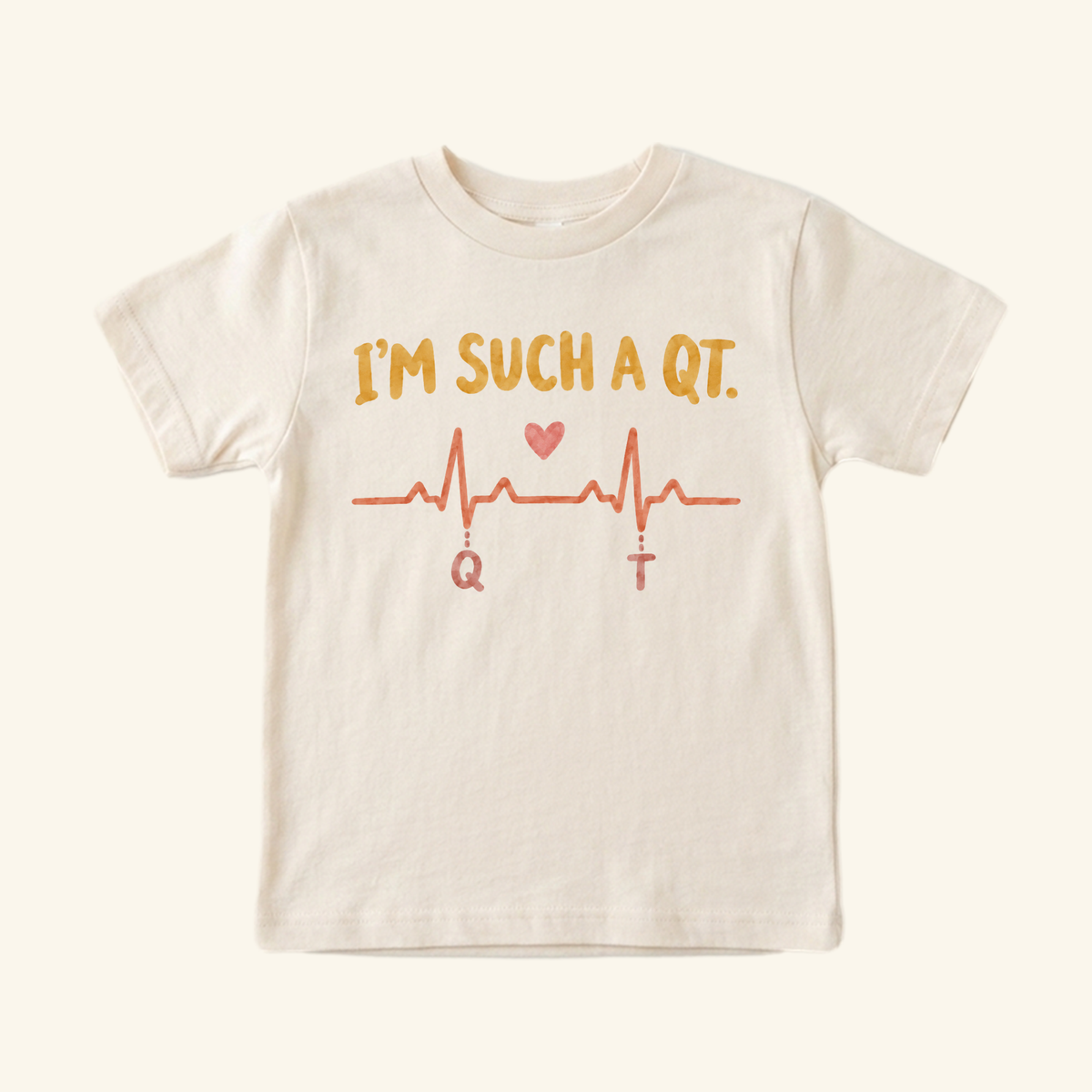 Cream I’m Such a QT Toddler Shirt featuring an EKG line with a heart and the letters Q and T below the peaks.
