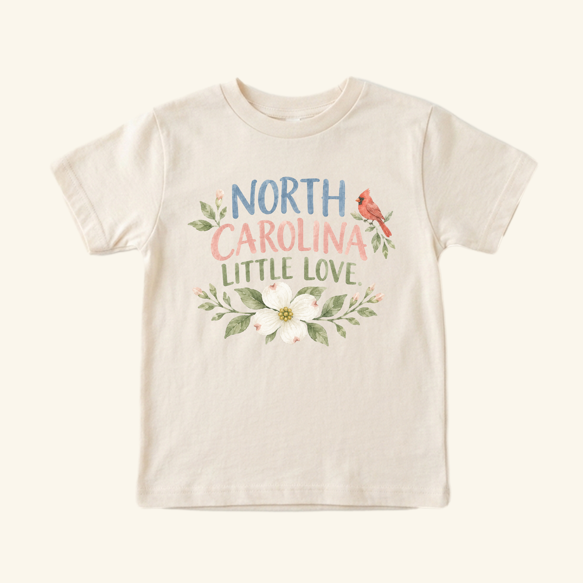 North Carolina Toddler Shirt – Little Love Dogwood & Cardinal Tee featuring a crewneck design with a flowering dogwood and cardinal graphic, perfect as a Southern keepsake.