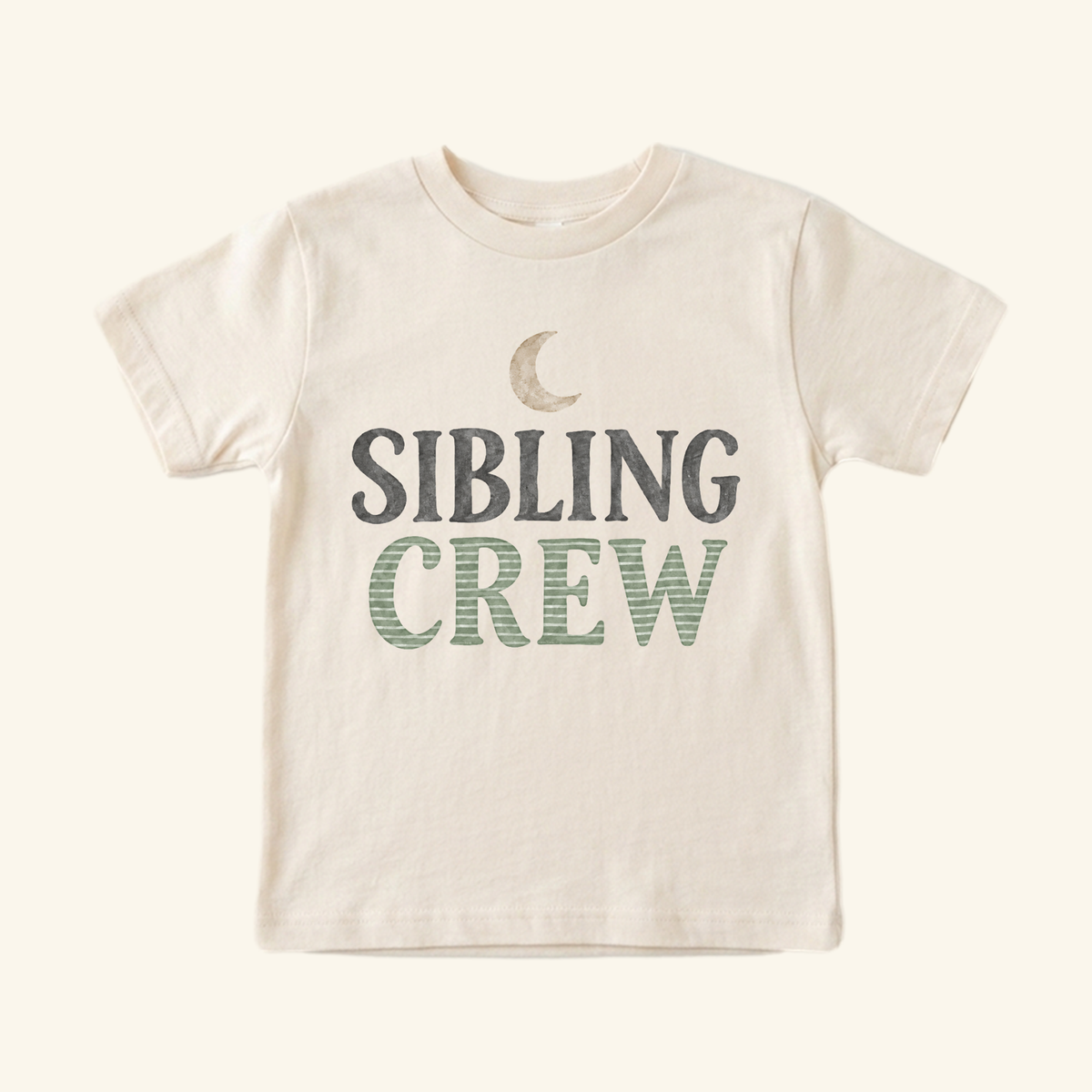 Cream-colored Sibling Crew Toddler Shirt – Moon Matching Sibling Tee with a graphic of a crescent moon.