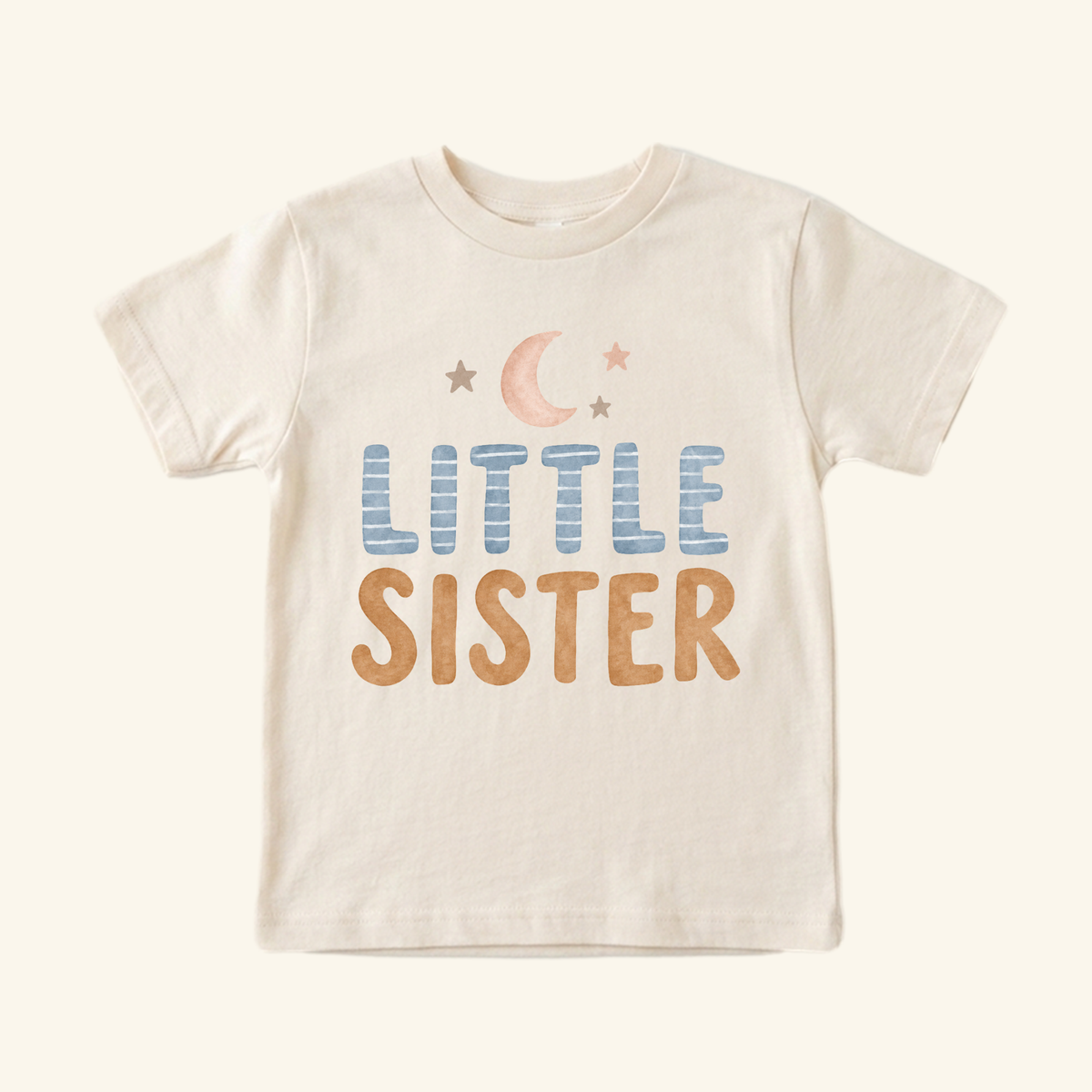 Beige Little Sister Toddler Shirt – Moon and Stars Sibling Tee featuring a moon and star graphic above blue and brown text.