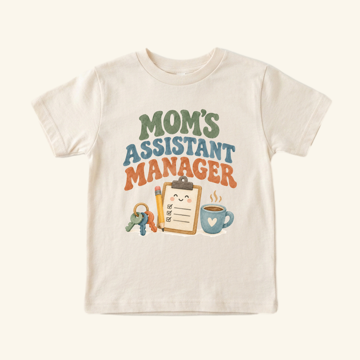 Cream-colored Mom’s Assistant Manager Toddler Shirt – Funny Retro Mom Tee featuring a graphic of a clipboard, pencil, keys, and coffee mug with retro-style lettering.