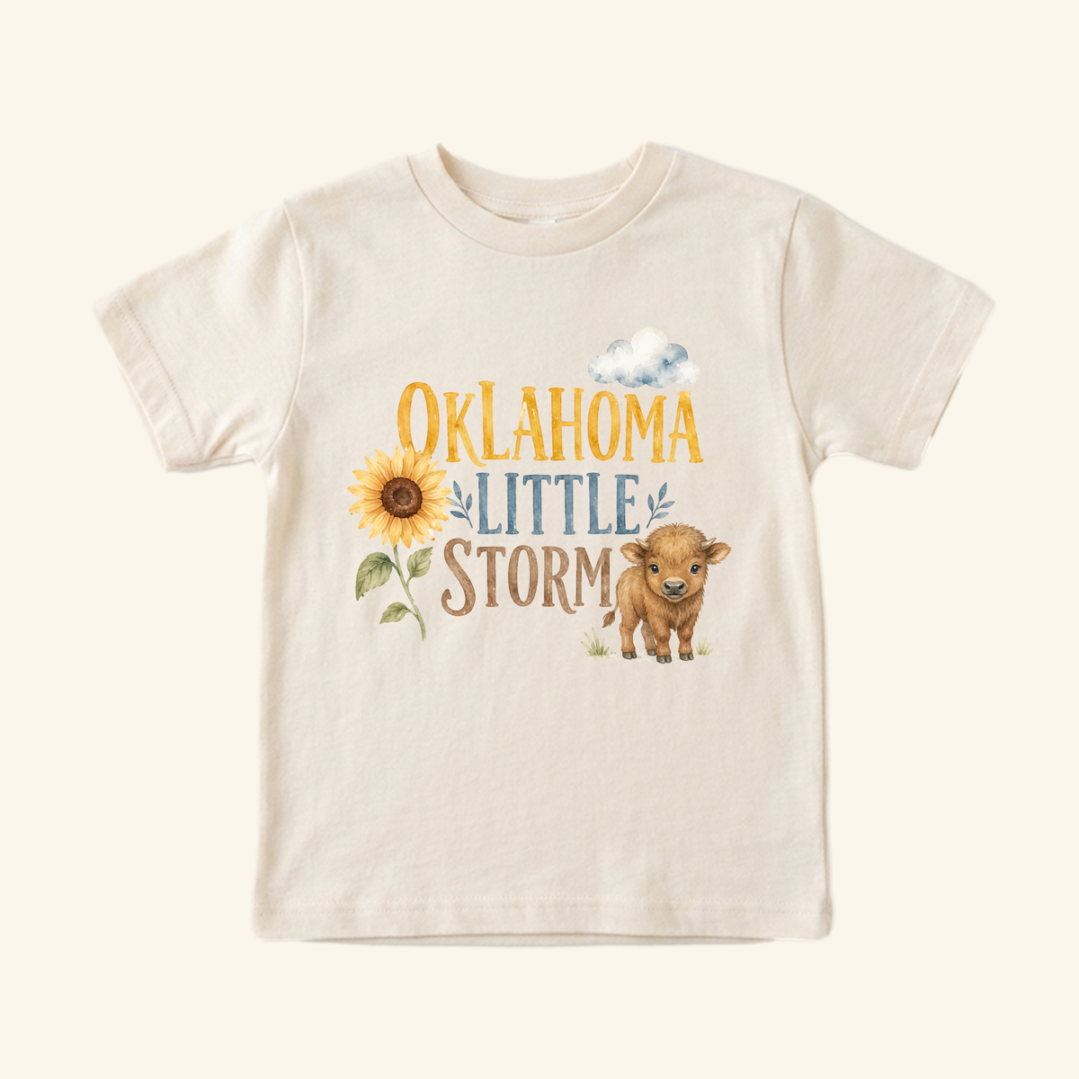 Toodleroos Oklahoma Toddler Shirt – Little Storm Sunflower & Baby Bison Tee in cream featuring a watercolor graphic of a sunflower, a baby bison, and a cloud with the text Oklahoma Little Storm.
