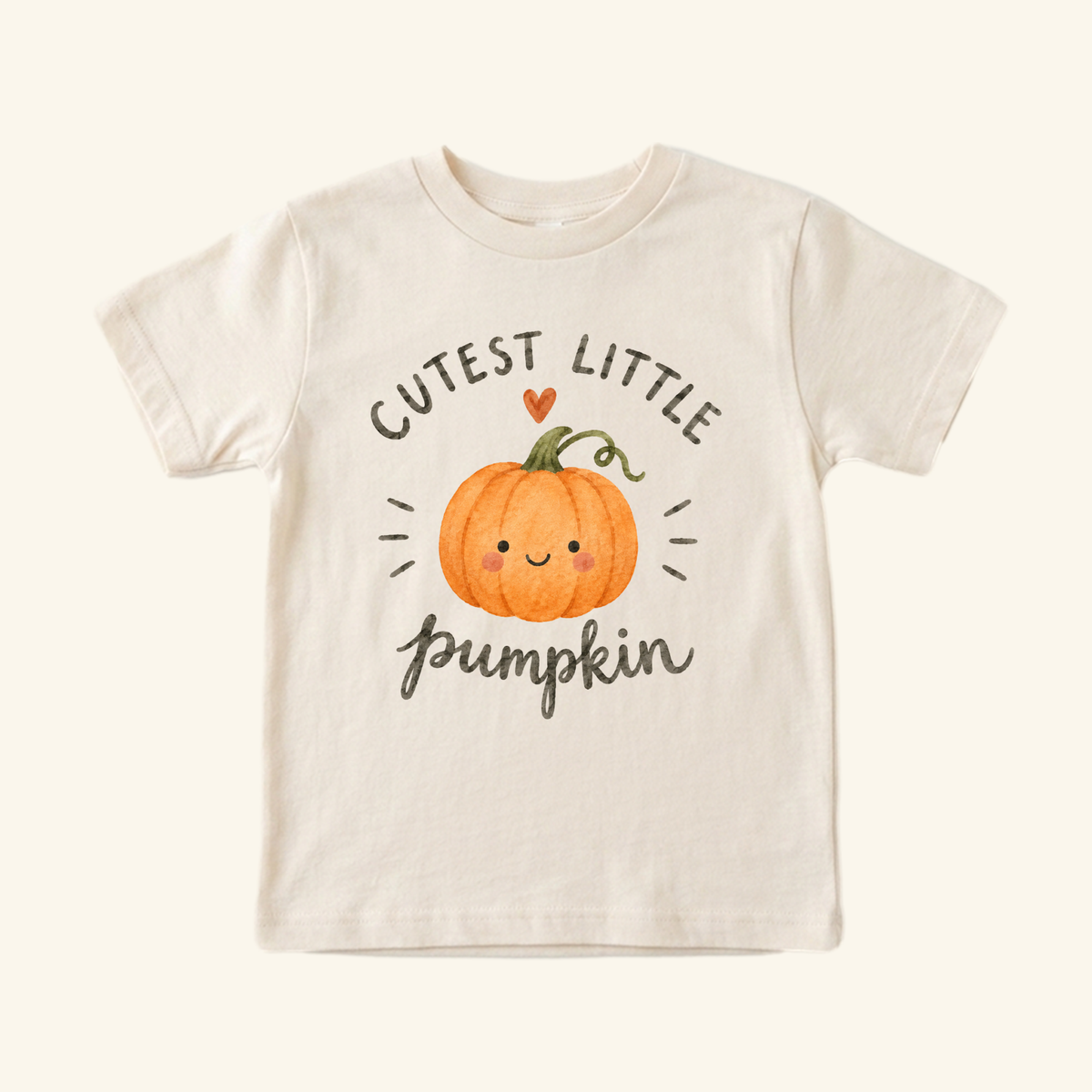 Off-white autumn Toodleroos Cutest Little Pumpkin Toddler Shirt featuring an illustration of a smiling pumpkin and the text, Cutest little pumpkin.
