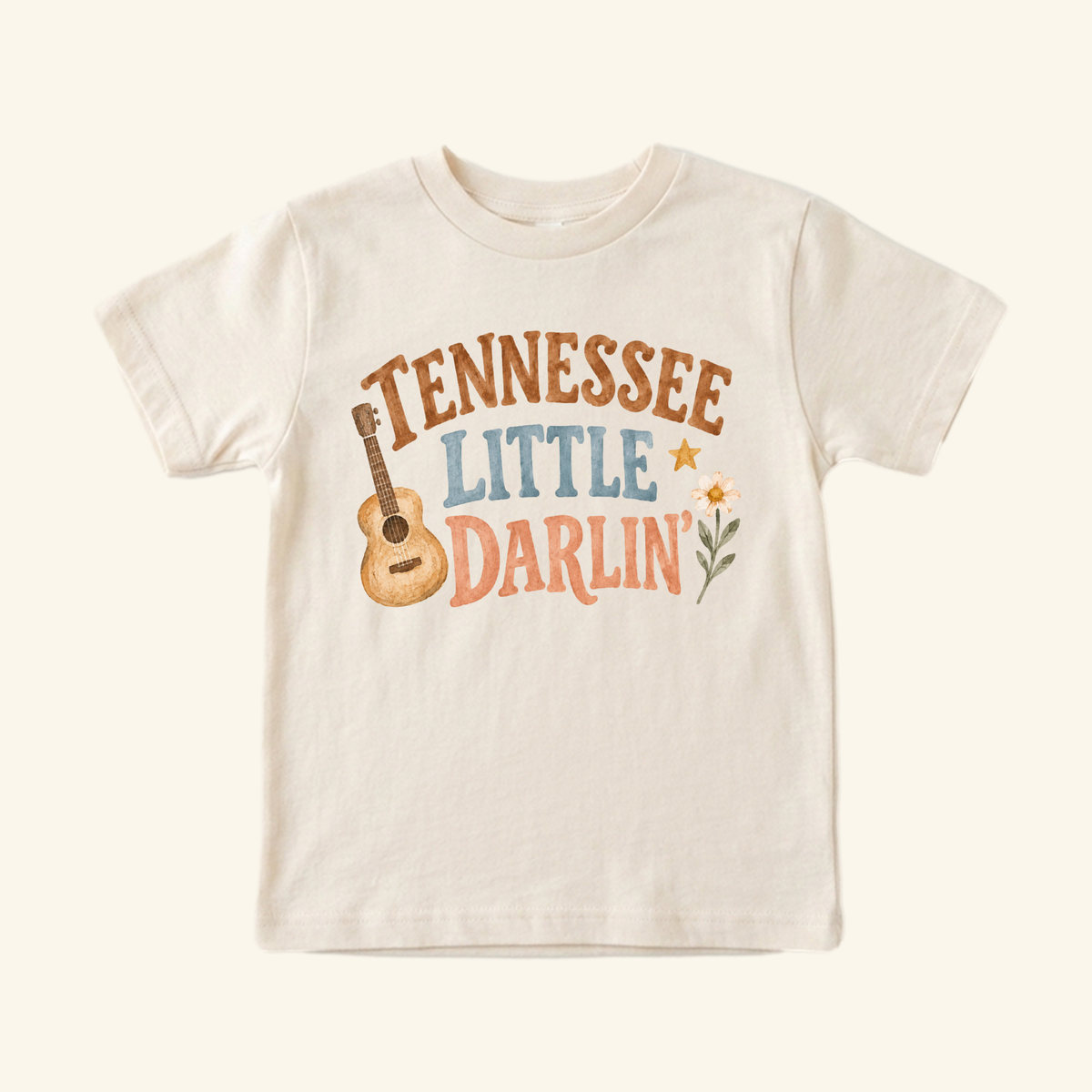 Cream-colored Tennessee Toddler Shirt – Little Darlin’ Guitar Country Tee featuring an acoustic guitar, a flower, a star, and the text Tennessee Little Darlin.