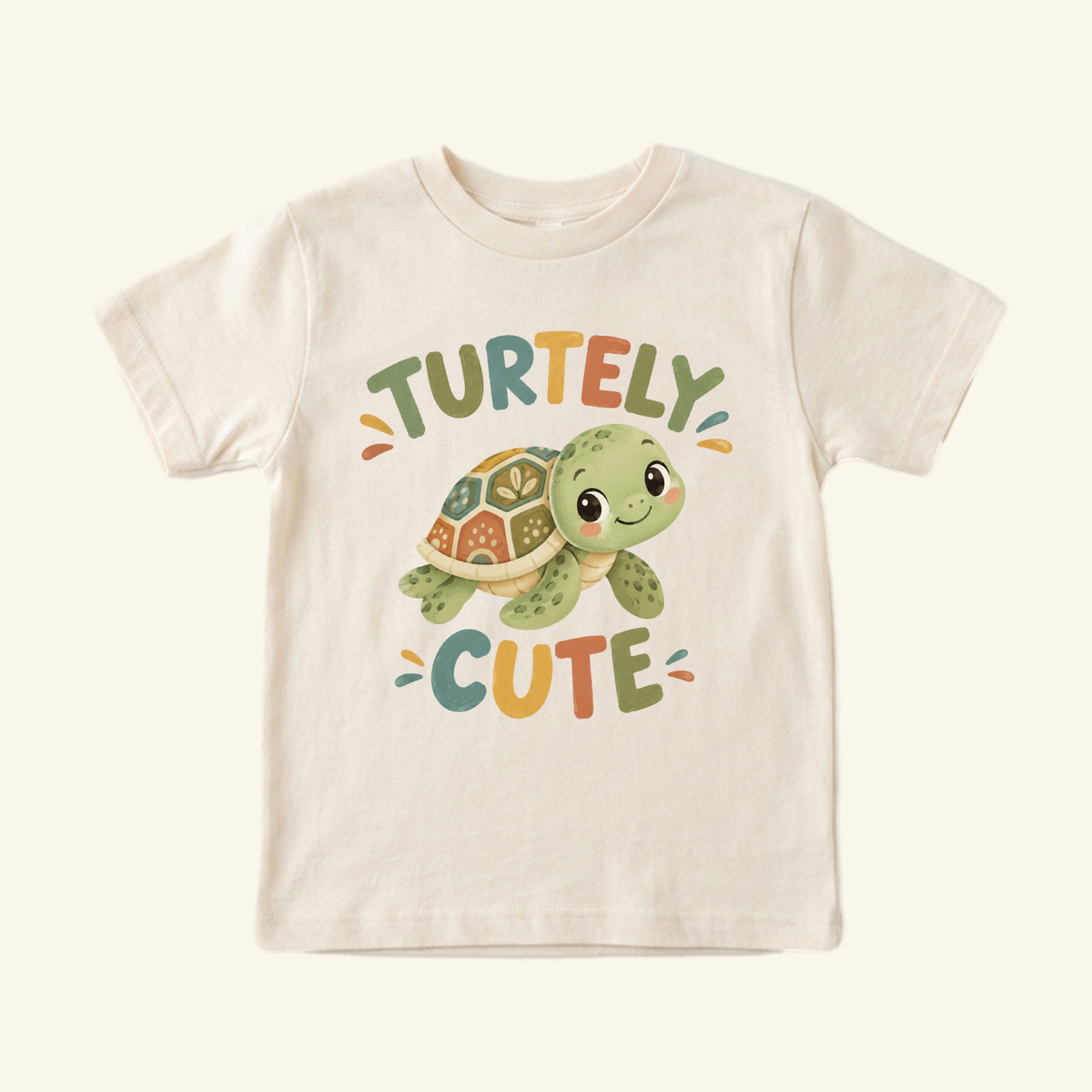 Toodleroos Turtley Cute Toddler Shirt – Watercolor Turtle Short-Sleeve Tee in beige featuring a watercolor turtle illustration and the text TURTELY CUTE in colorful letters.