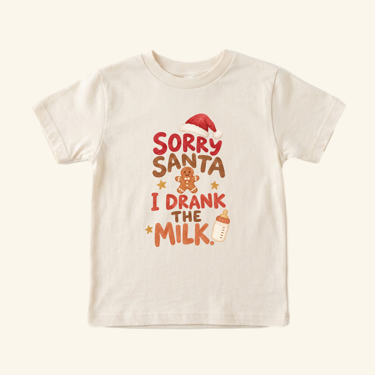 Cream-colored Sorry Santa I Drank the Milk Toddler Shirt – Funny Christmas Tee featuring red and brown text, a Santa hat, a gingerbread man, stars, and a baby bottle.