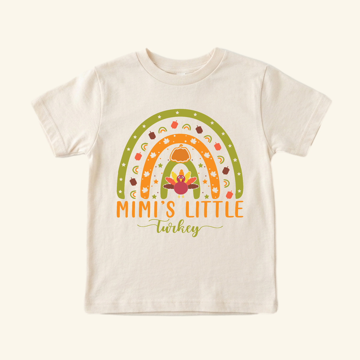 Mimi’s Little Turkey Toddler Shirt featuring a graphic of a Thanksgiving rainbow with a turkey, pumpkin, and leaves, above the text Mimi’s Little Turkey.