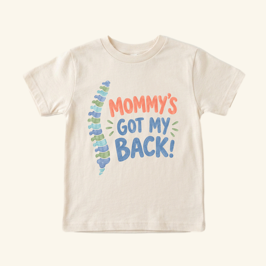 Mommy’s Got My Back Toddler Shirt featuring a watercolor spine anatomy graphic and the text Mommy’s Got My Back!.