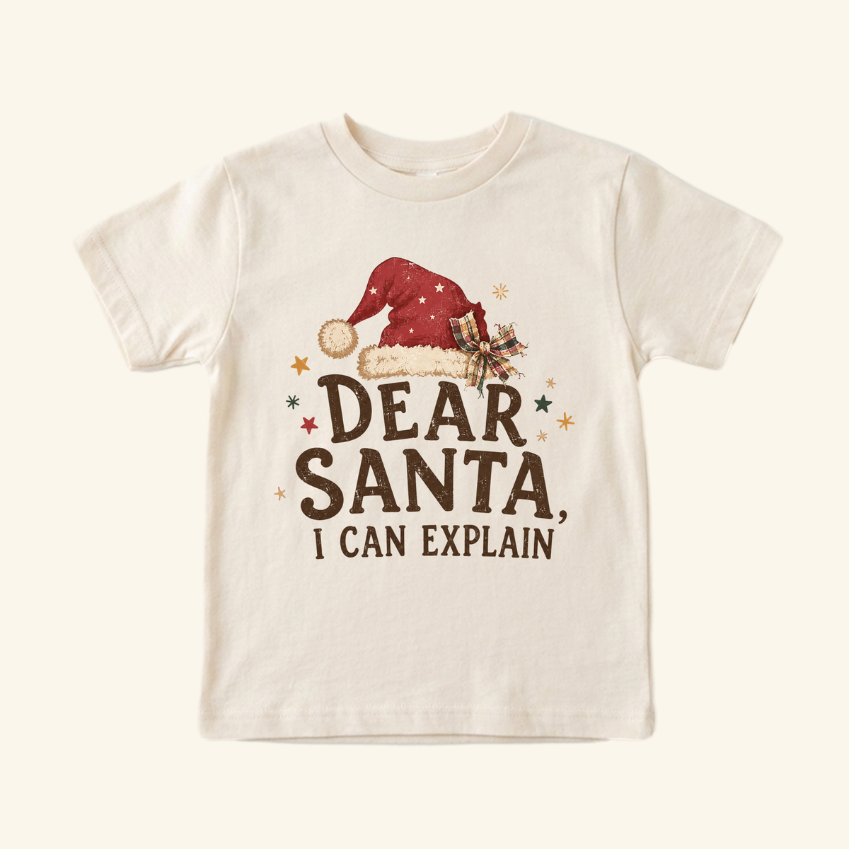 Cream Toodleroos Dear Santa, I Can Explain Toddler Shirt featuring a Santa hat and the text Dear Santa, I can explain.