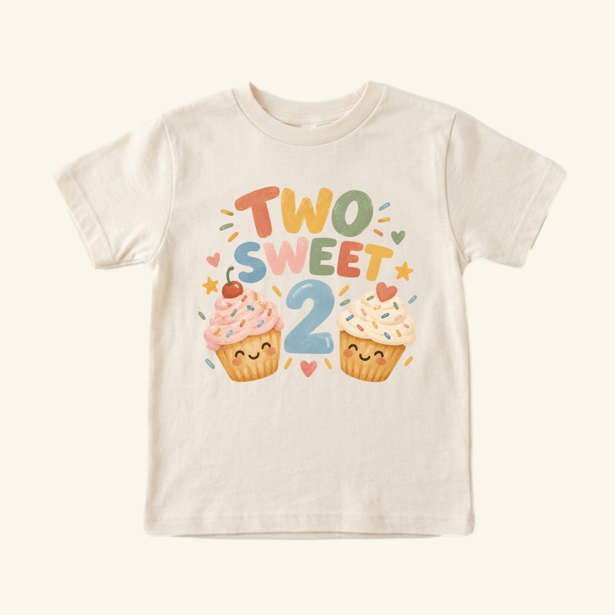 Off-white Two Sweet 2nd Birthday Toddler Shirt – Smiling Cupcake Short-Sleeve Tee featuring a large number 2 above two smiling, decorated cupcakes.
