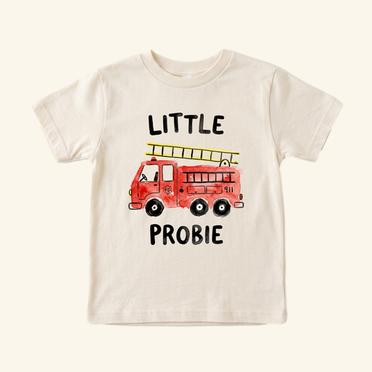 Cream-colored Little Probie Toddler Shirt – Firefighter Fire Truck Tee featuring a watercolor-style red fire truck with a yellow ladder and the text LITTLE PROBIE.