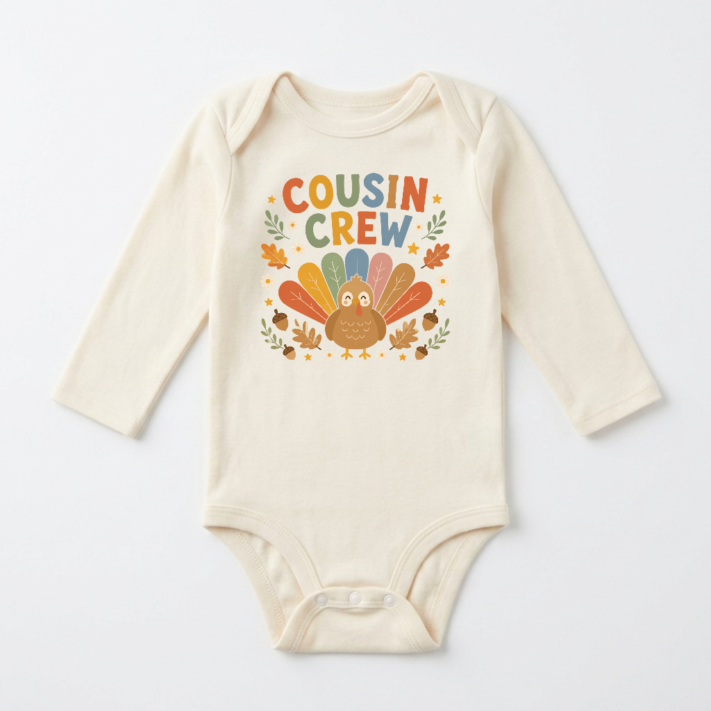 Dress your little one in the Toodleroos Long-Sleeve Thanksgiving Cousin Baby Onesie – a cream-colored bodysuit featuring a cheerful cartoon turkey, vibrant autumn leaves, and playful “Cousin Crew” text on the front. With orange, yellow, green, and blue accents, this adorable outfit is perfect for festive family gatherings!.