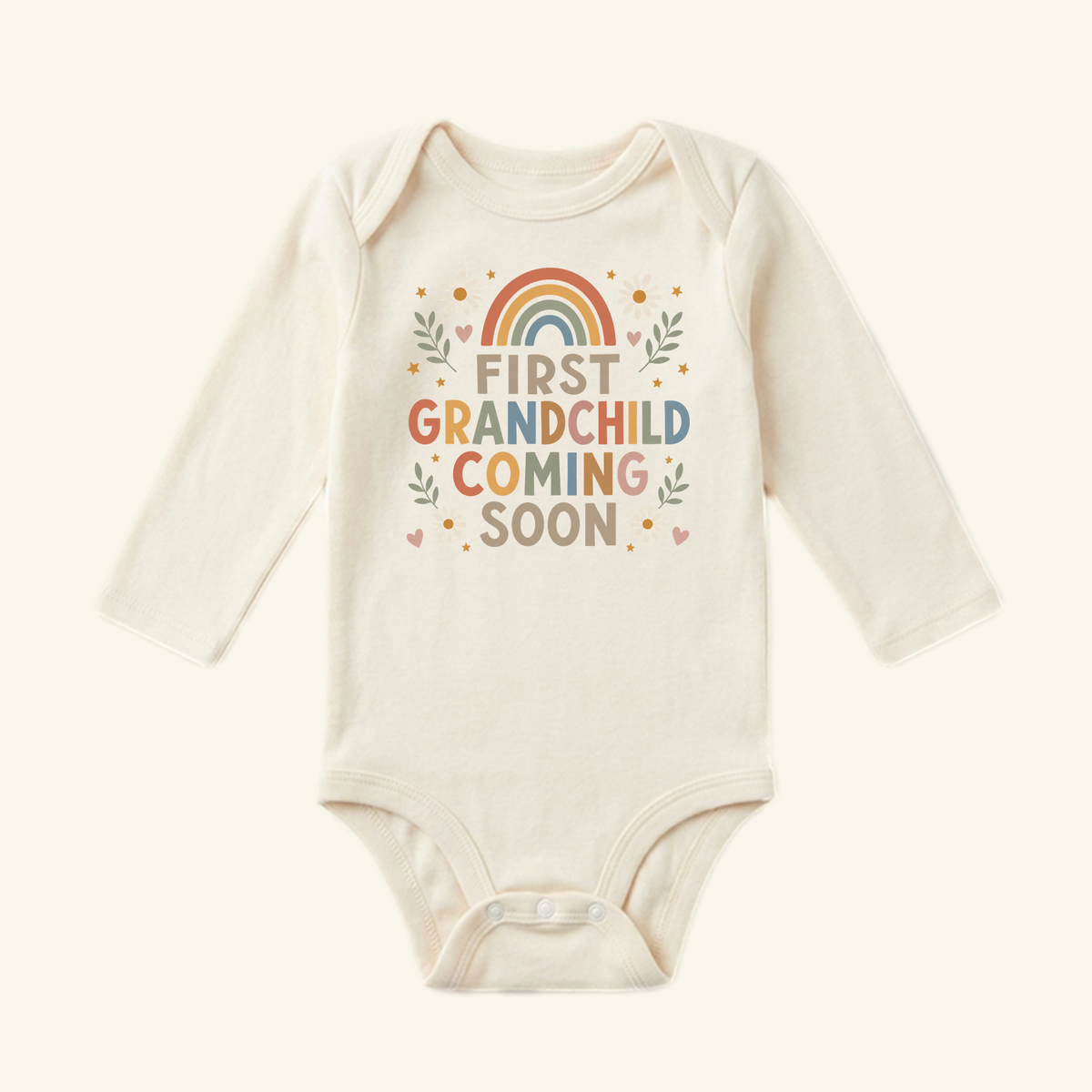 First Grandchild Announcement Baby Onesie – Coming Soon Bodysuit by Toodleroos, featuring a rainbow graphic and FIRST GRANDCHILD COMING SOON text surrounded by leaves and stars.