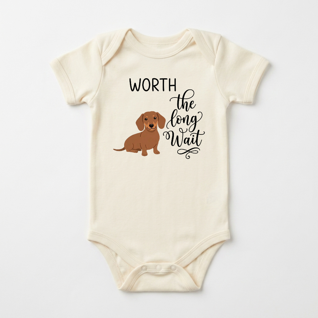The Worth the Long Wait Onesie – Baby Announcement Bodysuit is a cream baby outfit featuring a charming brown dachshund illustration and playful black script that says “Worth the long wait”—an ideal fertility treatment gift or a special hospital outfit for newborn arrivals.
