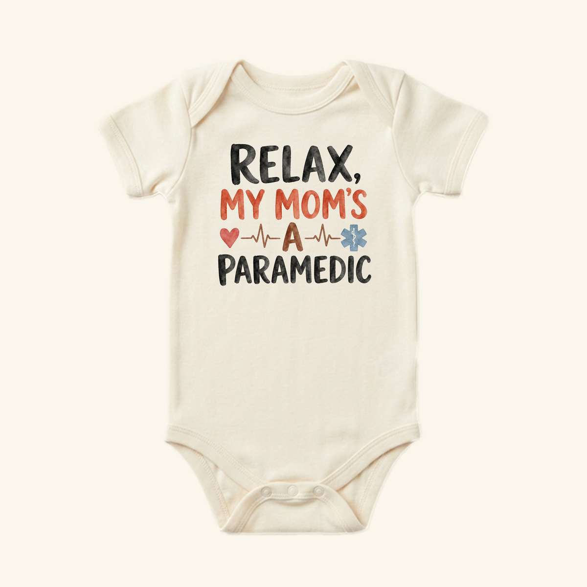 Cream-colored Paramedic Mom Baby Onesie – Relax My Mom’s a Paramedic Bodysuit featuring the text Relax, my mom’s a paramedic with an EKG line, a heart, and a medical star symbol.