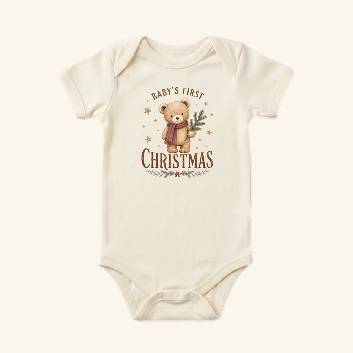 Off-white Baby’s First Christmas Baby Onesie – Teddy Bear Christmas Bodysuit featuring an illustration of a teddy bear wearing a scarf and holding a pine branch with the text Baby’s First Christmas.