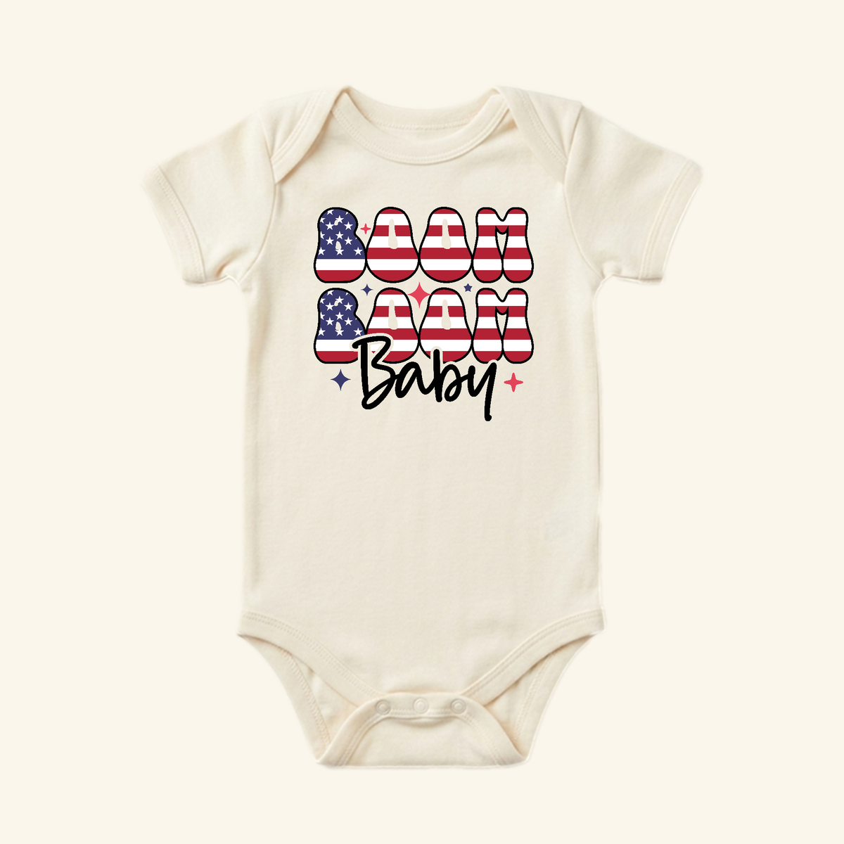 Cream-colored 4th of July Baby Onesie – Boom Boom Baby Patriotic Bodysuit featuring the text BOOM BABY in a red, white, and blue American flag pattern.