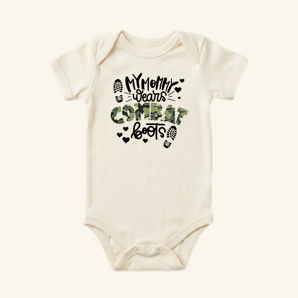 Off-white Military Baby Onesie – My Mommy Wears Combat Boots Bodysuit featuring the text My mommy wears combat boots in black and camouflage lettering, accented by small heart and boot-print icons.
