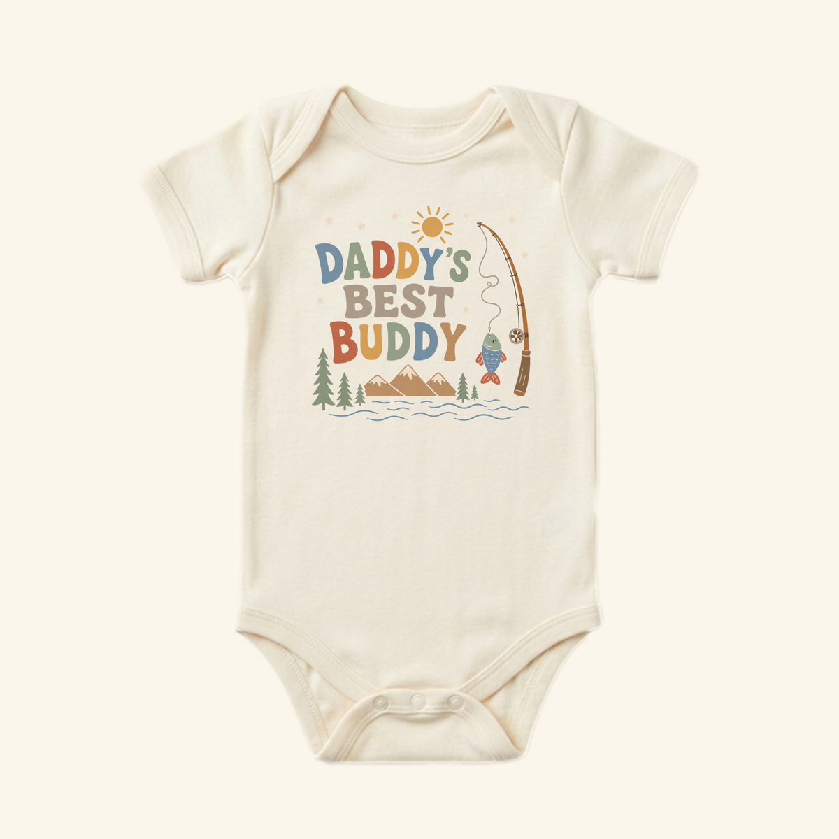 Toodleroos Daddy’s Best Buddy Baby Onesie – Fishing Bodysuit featuring a graphic of a fishing rod, a fish, and mountains with the text Daddy’s Best Buddy.