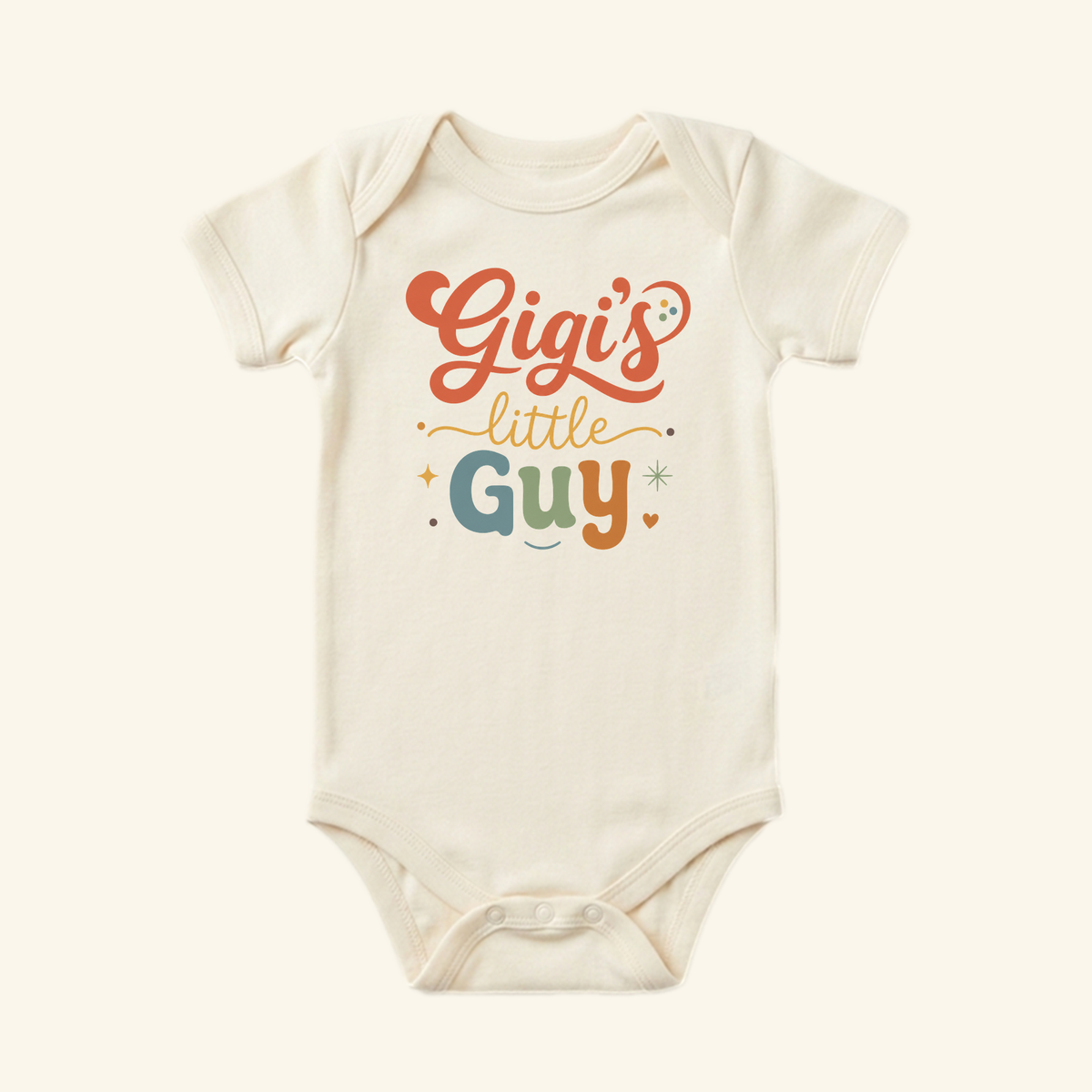 The Toodleroos Gigi’s Little Guy Baby Onesie – Grandson Bodysuit features Gigis little Guy in orange, yellow, and blue with stars and hearts—a sweet cream-colored outfit for your little one.