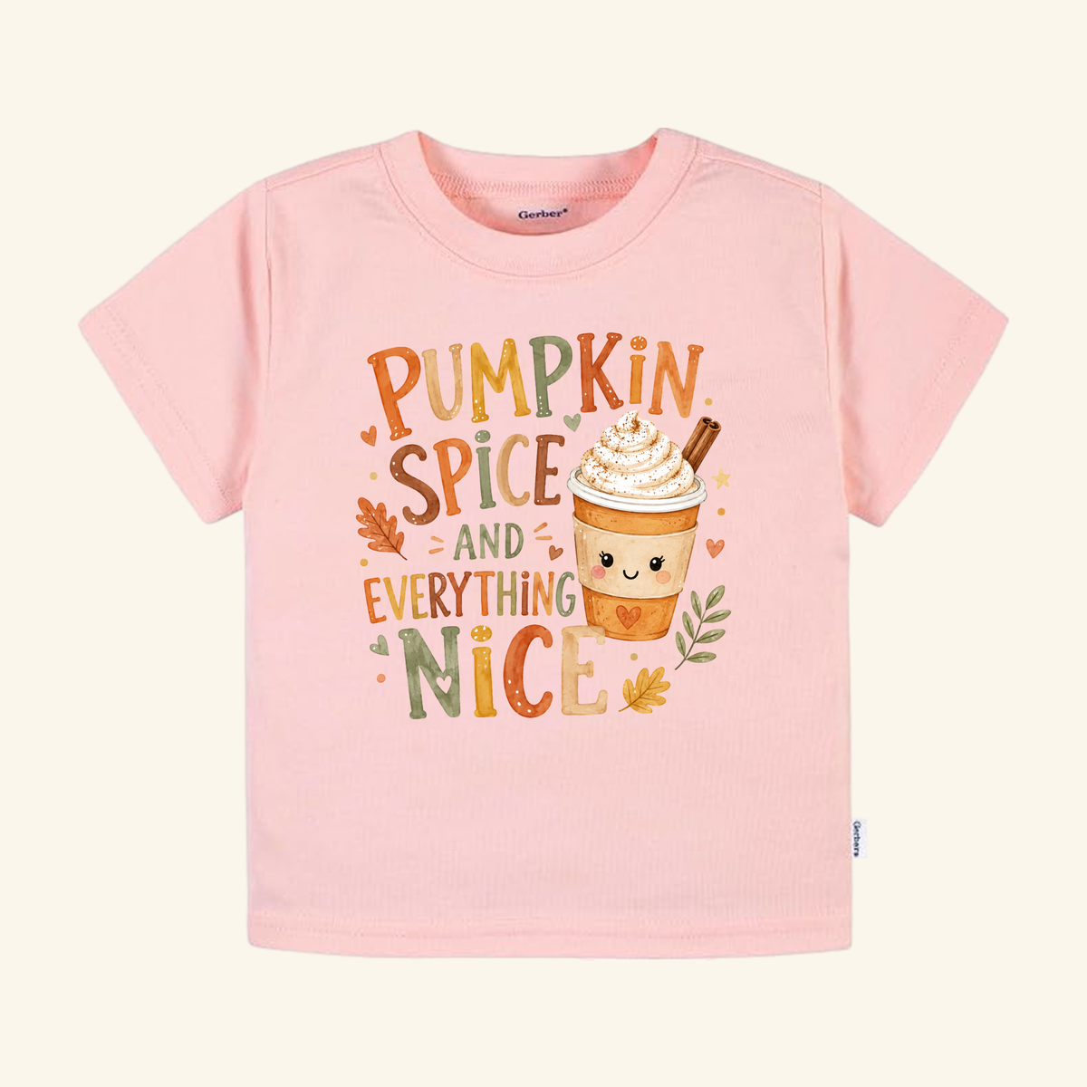 Light pink Pumpkin Spice and Everything Nice Toddler Shirt – Fall Latte Tee featuring a cute latte graphic with whipped cream and the text Pumpkin Spice and Everything Nice decorated with autumn leaves.