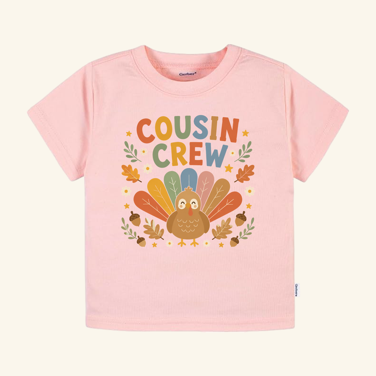 Light pink Toodleroos Thanksgiving Cousin Shirt – Cousin Crew Turkey Toddler Tee featuring a turkey with colorful feathers, the text COUSIN CREW, and autumn leaves and acorns.
