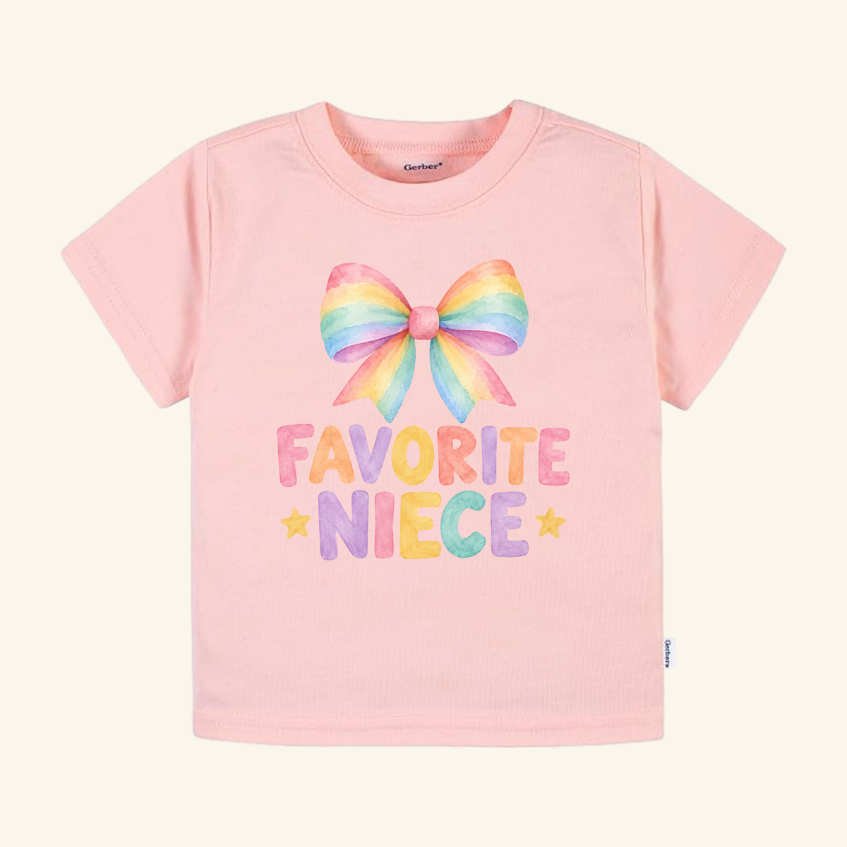 Favorite Niece Toddler Shirt – Cute Rainbow Bow Tee in light pink with a watercolor-style rainbow bow, the text FAVORITE NIECE in colorful, blocky letters, and two small yellow stars.