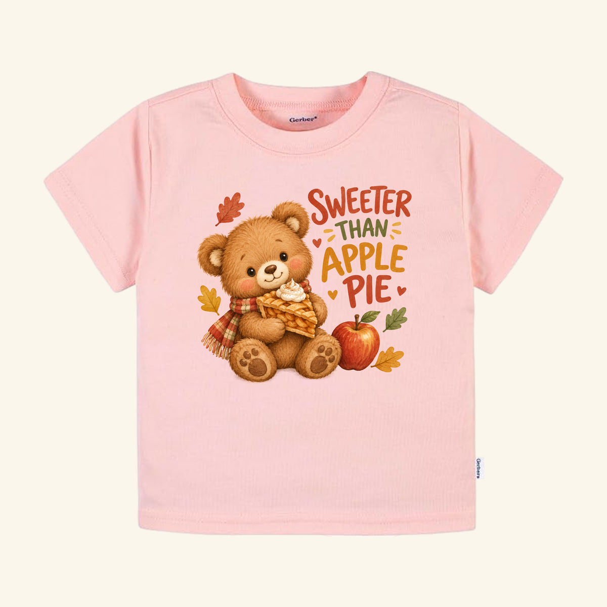 Light pink Sweeter Than Apple Pie Toddler Shirt – Fall Bear Short-Sleeve Tee featuring a bear wearing a scarf and holding a slice of pie, with the text Sweeter Than Apple Pie and autumn leaves.