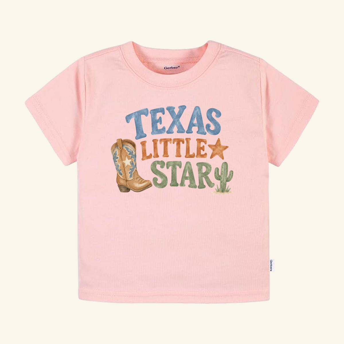 Light pink Texas Toddler Shirt – Little Star Cowboy Boot Western Tee featuring a graphic of a cowboy boot, a star, a cactus, and the text Texas Little Star.