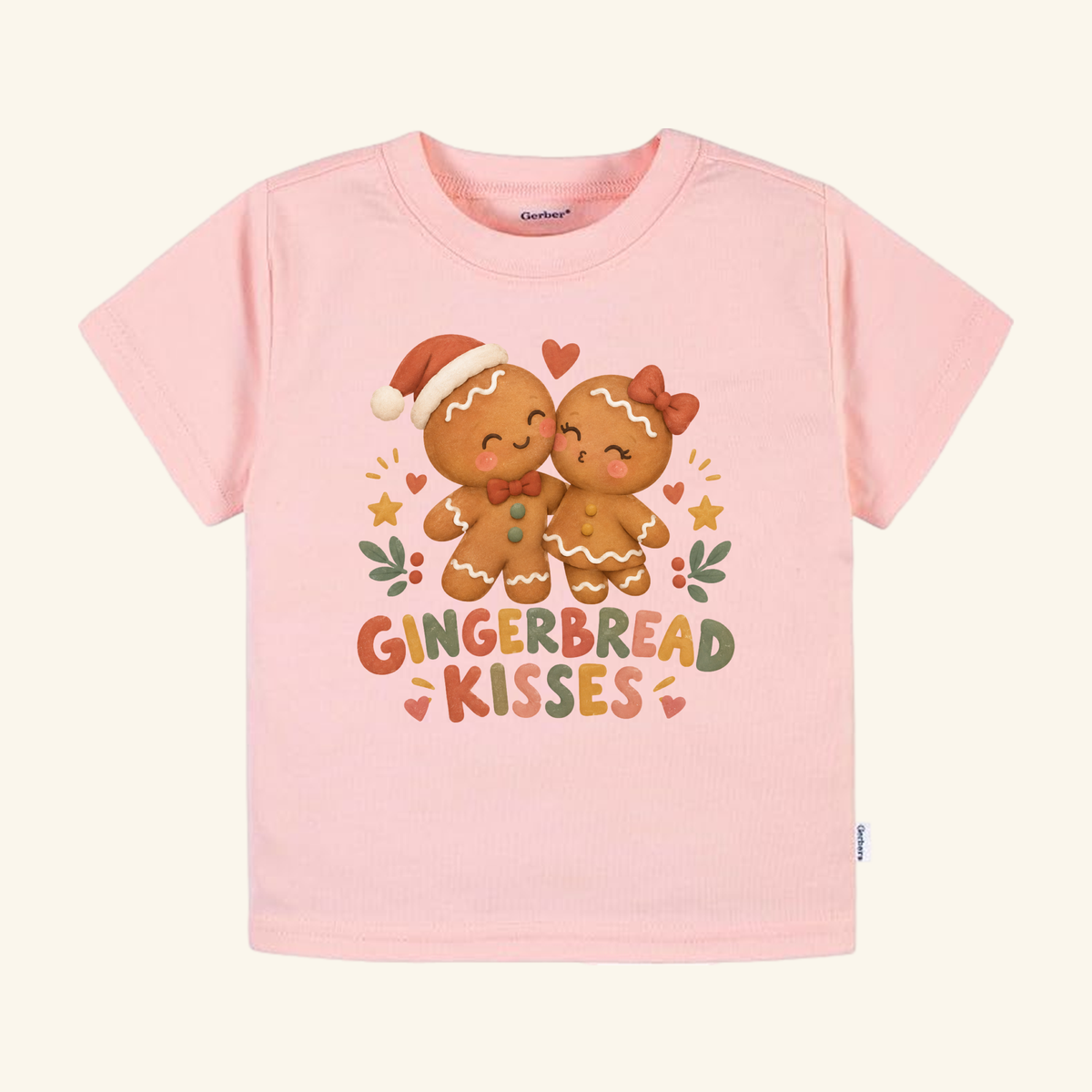 Pink Gingerbread Kisses Toddler Shirt – Cute Christmas Gingerbread Couple Tee featuring two gingerbread cookies kissing, surrounded by hearts and stars with Gingerbread Kisses text below.