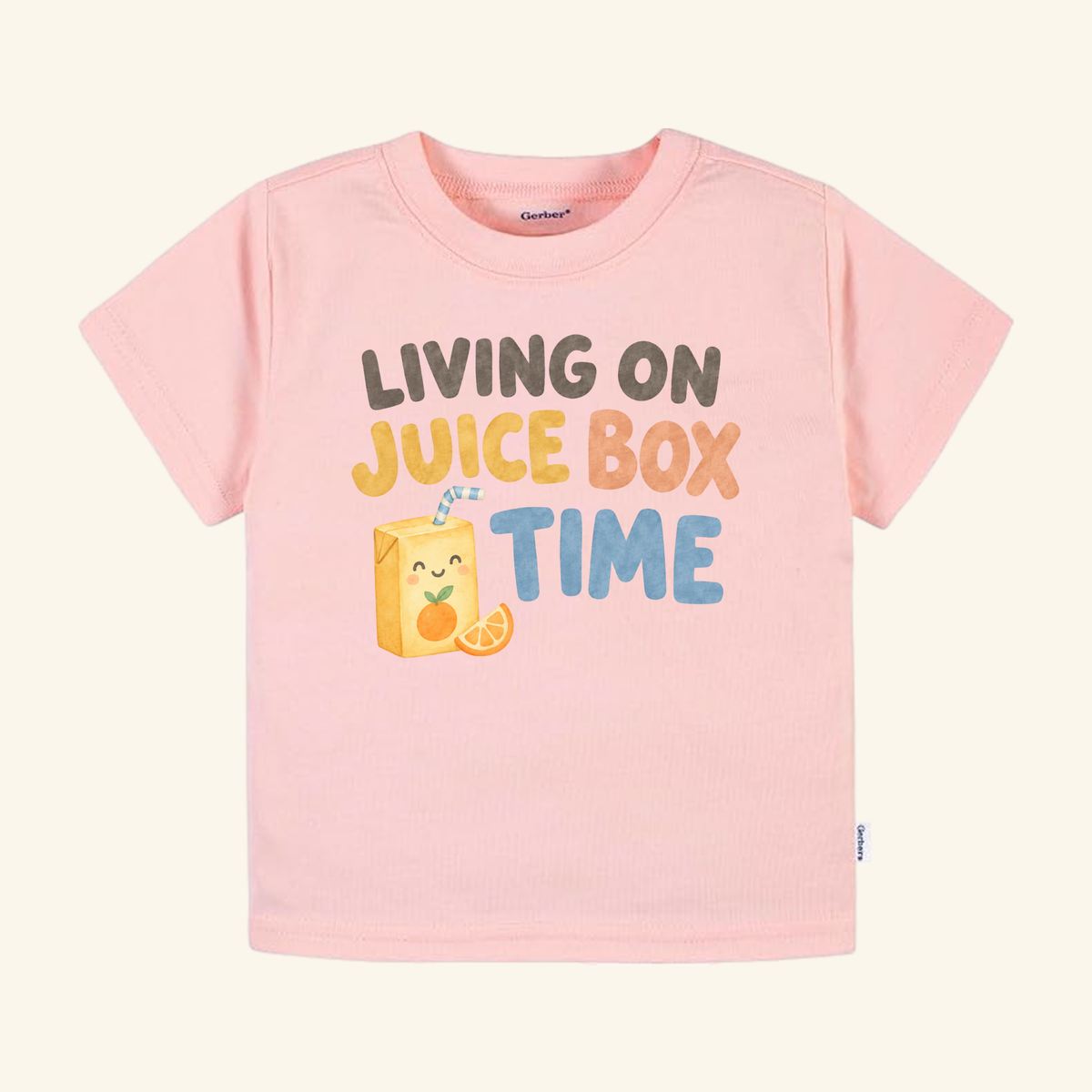 Light pink Living on Juice Box Time Toddler Shirt featuring a funny juice box graphic with a smiling face and the text LIVING ON JUICE BOX TIME.
