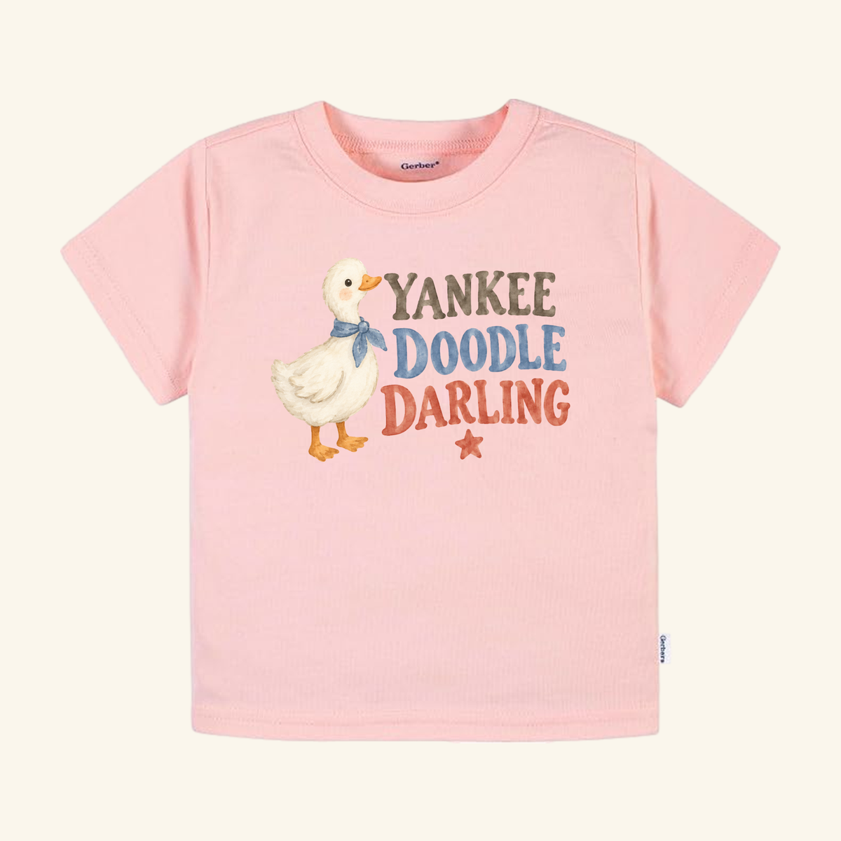 Toodleroos Yankee Doodle Darling Toddler Shirt in light pink, featuring a duckling wearing a blue neckerchief, a small red star, and the text Yankee Doodle Darling.