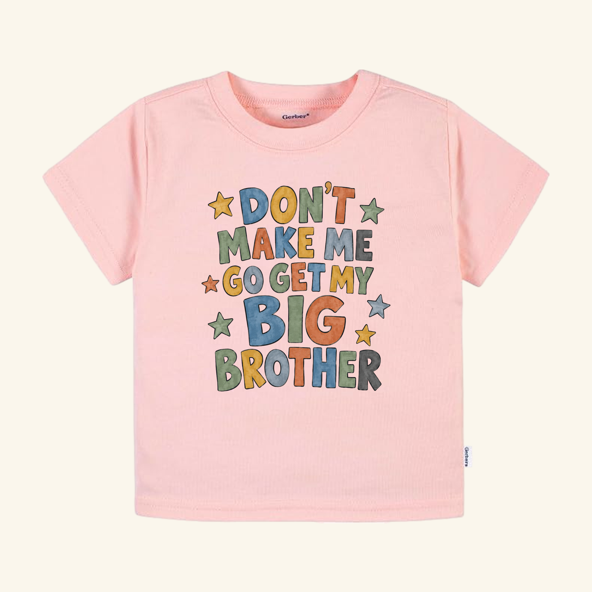 Light pink Don’t Make Me Go Get My Big Brother Toddler Shirt – Funny Sibling Tee featuring the text DONT MAKE ME GO GET MY BIG BROTHER surrounded by colorful stars.