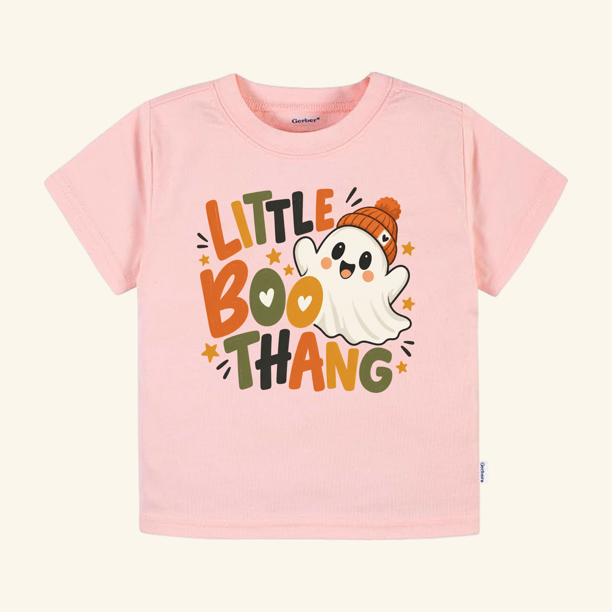 Light pink toddler t-shirt featuring a cute ghost wearing an orange beanie and the text Little Boo Thang in colorful lettering; this is a Toodleroos Little Boo Thang Ghost Toddler Halloween Shirt.
