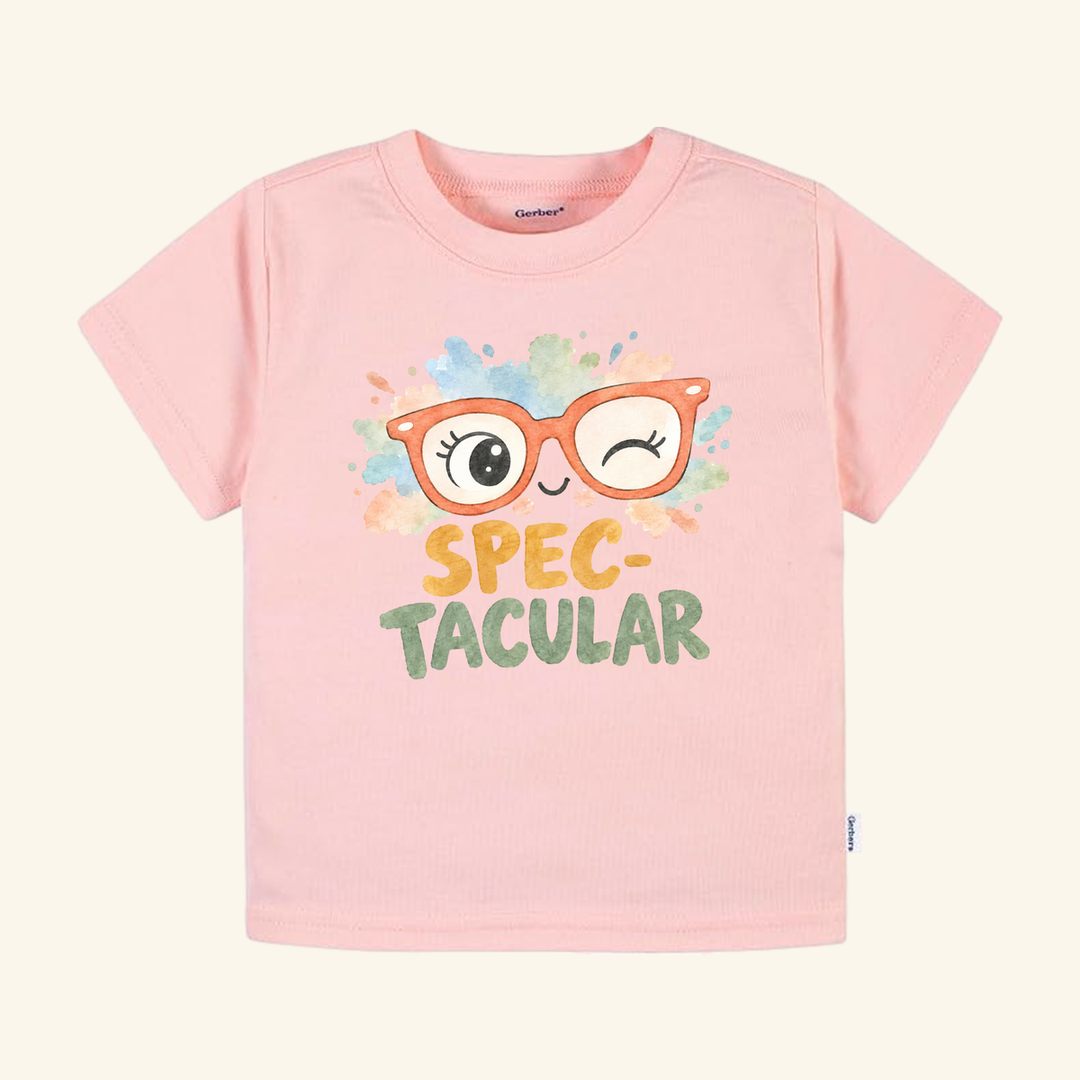 Spec-tacular Toddler Shirt – Cute Winking Glasses Tee in light pink featuring a graphic of orange winking glasses and the word SPEC-TACULAR above a colorful watercolor splash.