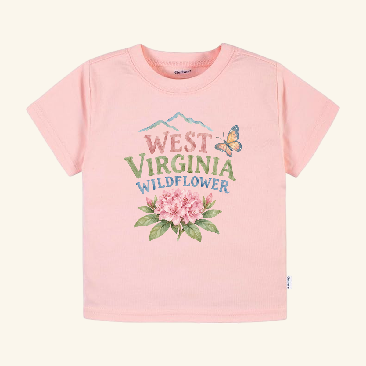 West Virginia Toddler Shirt – Wildflower Rhododendron Tee in light pink featuring a watercolor print of mountains, a butterfly, and rhododendron flowers with the text West Virginia Wildflower.