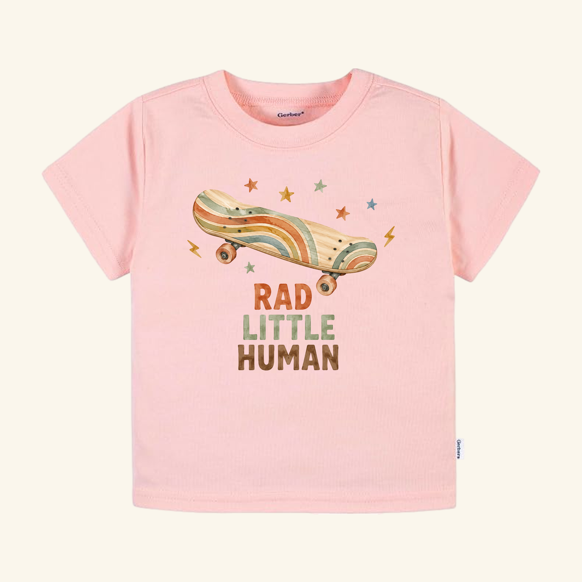 Light pink Skateboard Toddler Shirt – Rad Little Human Retro Tee featuring a retro skateboard graphic, colorful stars, and the text RAD LITTLE HUMAN.
