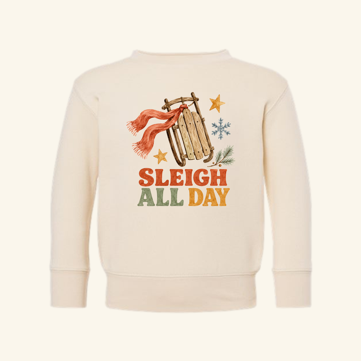 Cream Sleigh All Day Toddler Sweatshirt – Retro Christmas Sled Pullover featuring a retro Christmas sled graphic with a red scarf, a snowflake, two stars, and the text SLEIGH ALL DAY.