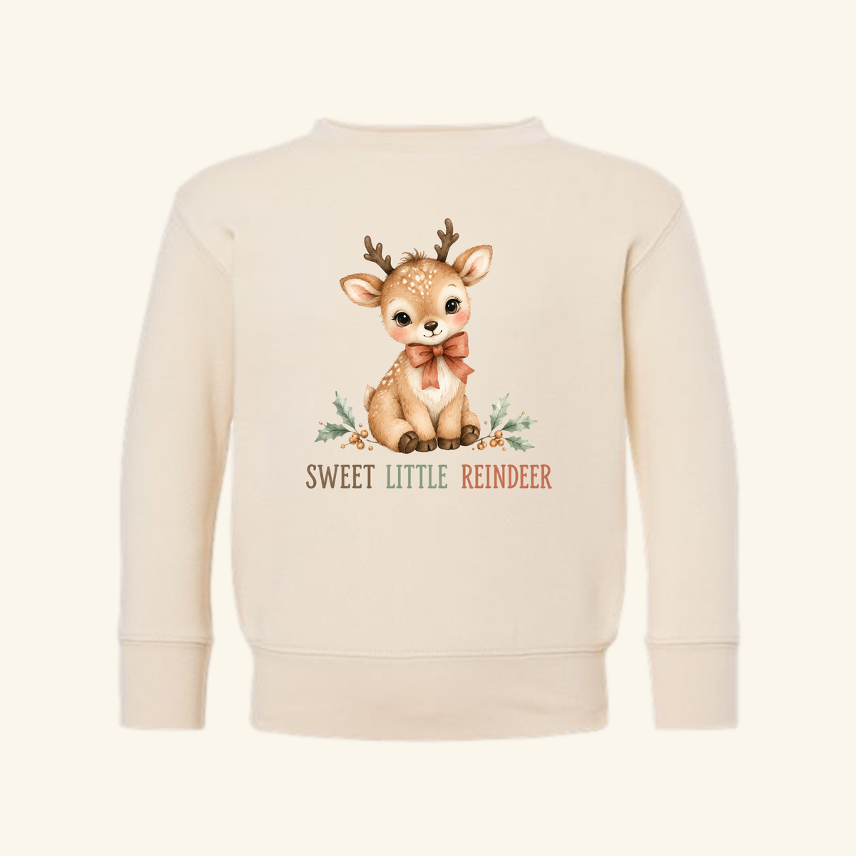 Cream-colored Sweet Little Reindeer Toddler Sweatshirt – Christmas Pullover featuring a drawing of a seated fawn with a ribbon bow, surrounded by holly leaves and the text SWEET LITTLE REINDEER.