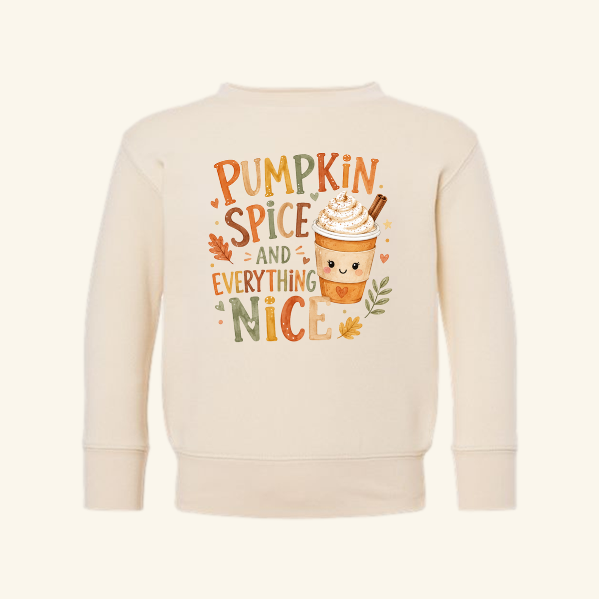 Cream-colored Pumpkin Spice and Everything Nice Toddler Sweatshirt – Fall Latte Pullover featuring a smiling latte cup, surrounded by small leaves and hearts, with the text PUMPKIN SPICE AND EVERYTHING NICE.