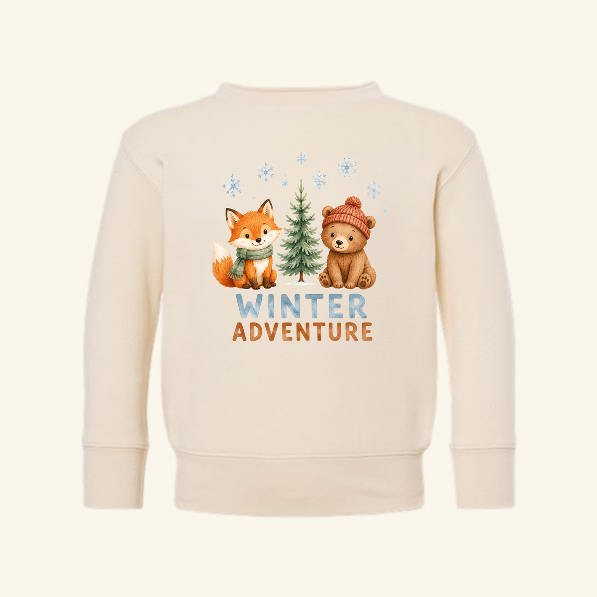Cream-colored Winter Adventure Toddler Sweatshirt – Woodland Fox & Bear Pullover featuring a watercolor illustration of a fox in a scarf and bear in a beanie by a pine tree, with snowflakes and the text Winter Adventure below.