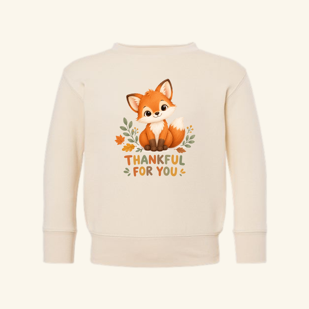 Cream-colored Thankful for You Toddler Sweatshirt featuring a cartoon fox illustration and autumnal text.