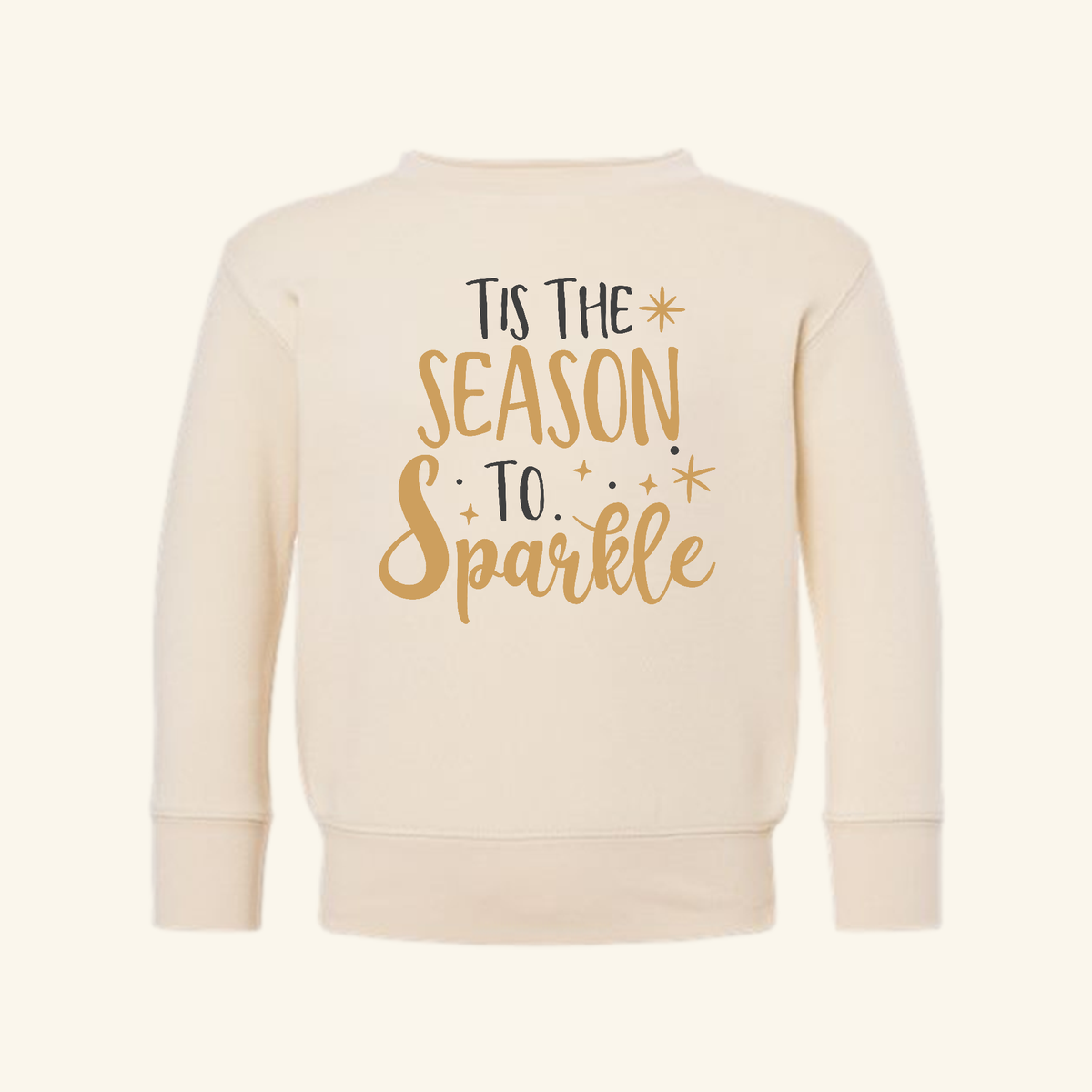 Cream-colored Tis the Season to Sparkle Toddler Sweatshirt with Tis the season to sparkle printed in gold and black on the front.