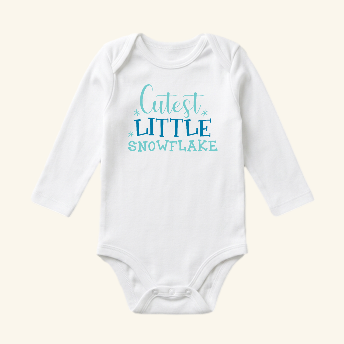 Toodleroos Winter Baby Onesie – Cutest Little Snowflake Bodysuit featuring a white long-sleeve snowflake print with the text Cutest Little Snowflake in blue on the chest.