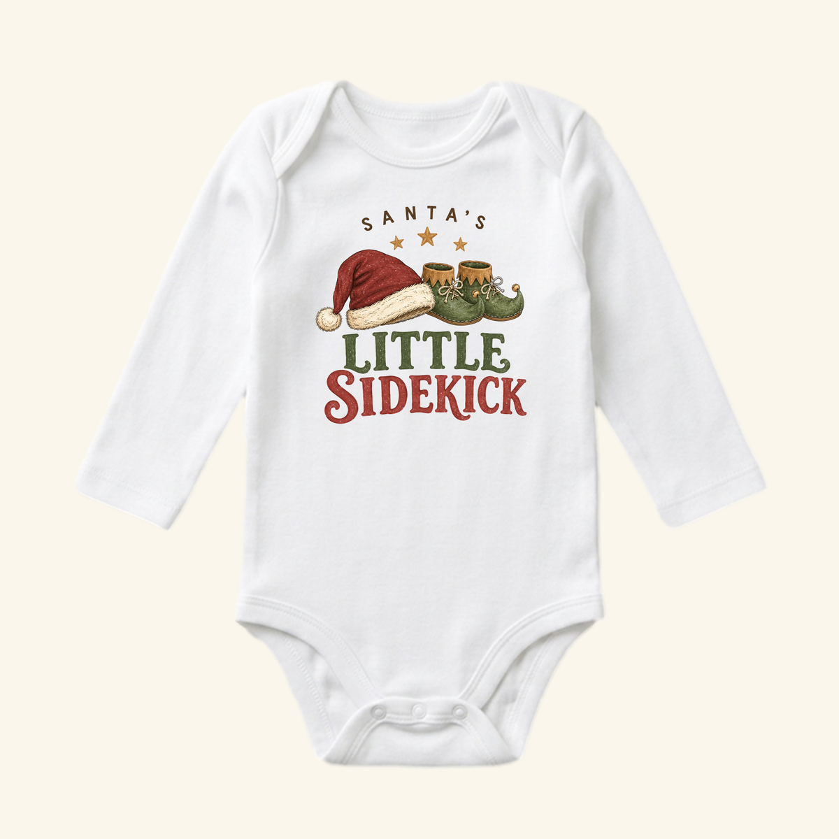 White long-sleeve Santa’s Little Sidekick Baby Onesie – Christmas Elf Bodysuit featuring a graphic of a Santa hat, elf shoes, and the text Santa’s Little Sidekick.