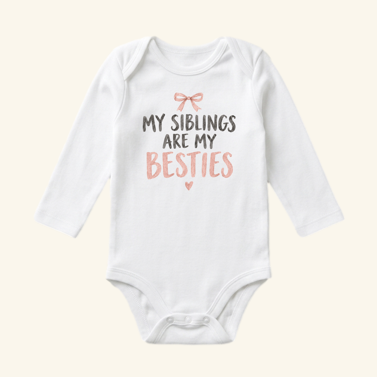 My Siblings Are My Besties Baby Onesie – Pink Bow Sibling Bodysuit in white with long sleeves, a pink bow graphic, and the text MY SIBLINGS ARE MY BESTIES.