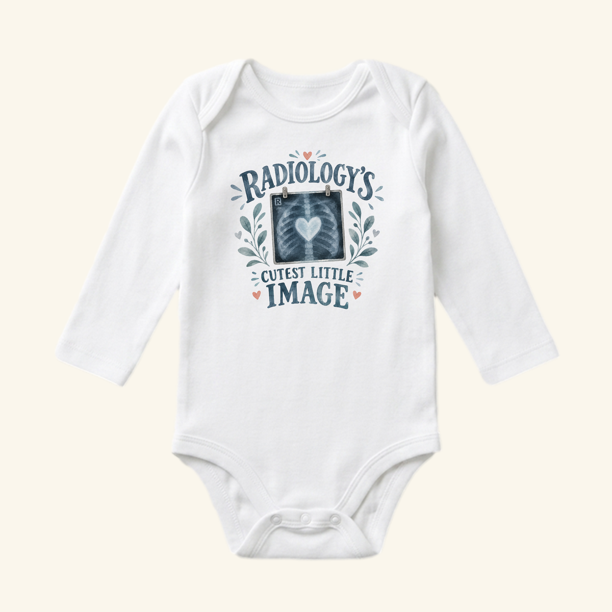 Toodleroos Radiology’s Cutest Little Image Baby Onesie – Rad Tech Bodysuit in white, featuring a long-sleeve design with an X-ray heart graphic, botanical illustrations, and the text, Radiology’s Cutest Little Image.